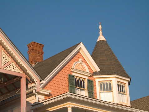 This is a colorful shot of a victorian homes roof.