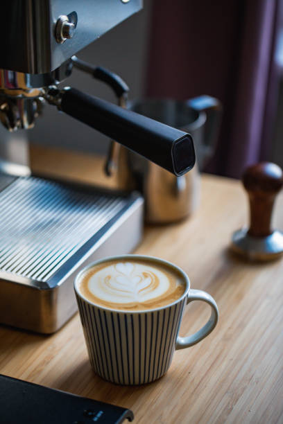 istock Latte art on wooden table with coffee equipments 1393878267