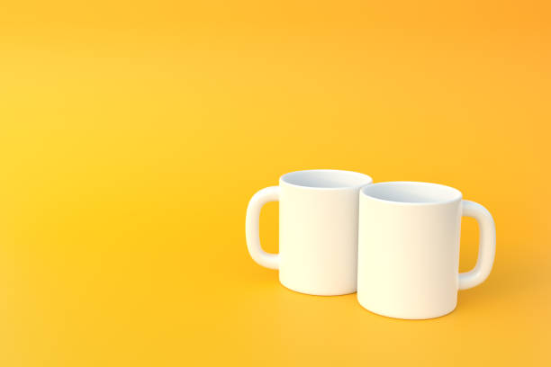 istock Two white ceramic cup or empty mug for coffee, drink or tea on yellow background 1393878475