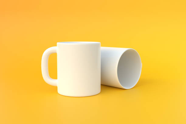 istock Two white ceramic cup or empty mug for coffee, drink or tea on yellow background 1393878476