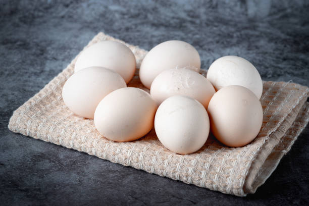 istock Chicken eggs on beige towel on grey background 1393878485