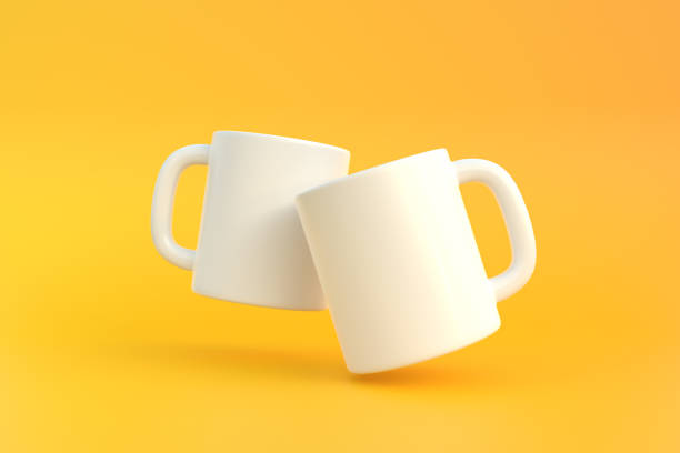 istock Two white ceramic cup or empty mug for coffee, drink or tea on yellow background 1393878505