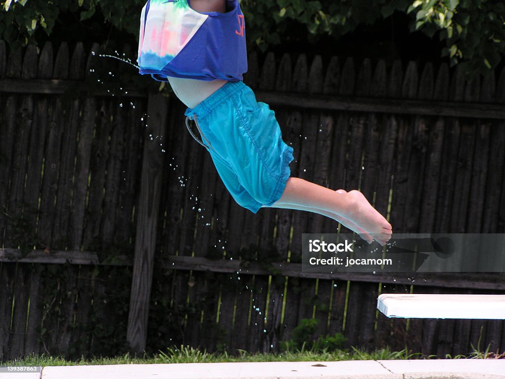 Something is Missing "Headless" boy jumping off diving board into swimming pool.         Absence Stock Photo