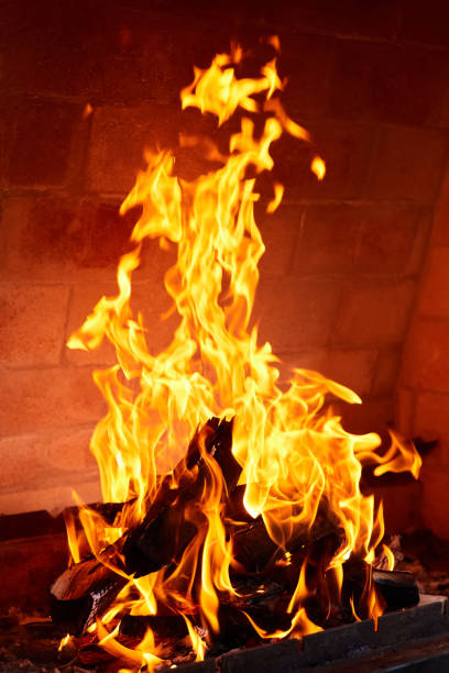 istock Orange flame from burning firewood in a brick grill. Close-up, selective focus 1393880692