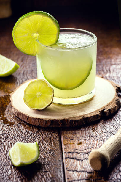 caipirinha, a typical brazilian summer drink served with ice, lemon vodka or cachaça. - caipiroska imagens e fotografias de stock