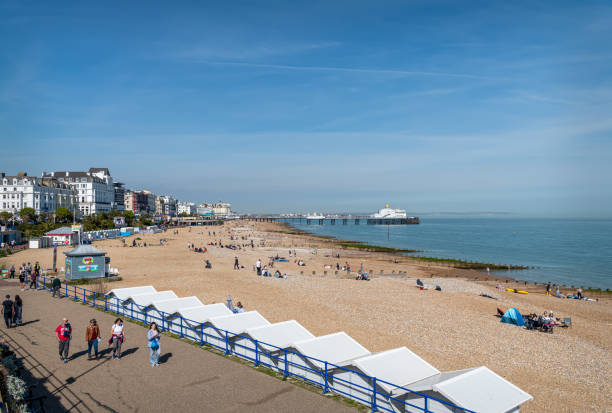 The beach and promenade with the Pier in the background, Eastbourne, England The beach and promenade with the Pier in the background, Eastbourne, England eastbourne pier photos stock pictures, royalty-free photos & images