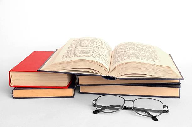 istock Open book on a stack of books with reading glasses 139388148