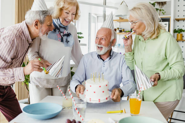 istock Senior man celebrating birthday with friends 1393881846