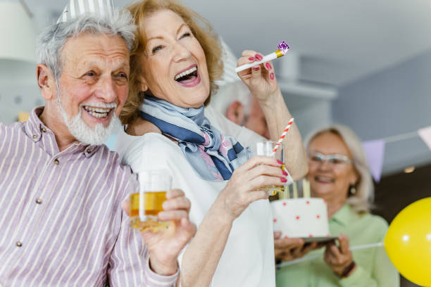 istock Cheerful senior group having great time on a birthday party 1393881930