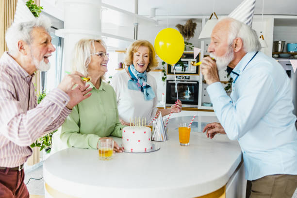 istock Senior group dancing and singing on a birthday party 1393881965