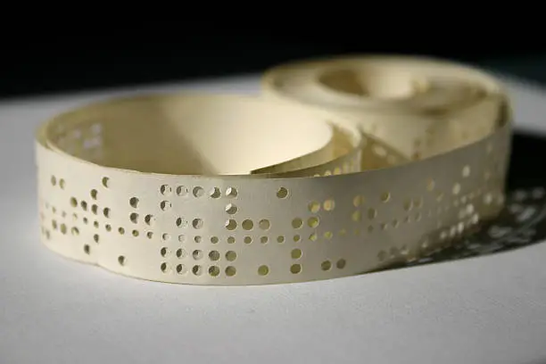 Punched tape is an old-fashioned form of data storage, consisting of a long strip of paper in which holes are punched to store data.