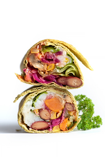 Grilled burritos wrap with vegetable with beans,corn,tomatoes,avocado sweet potatoes isolated on white.