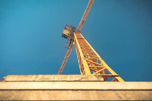 Construction tower crane against blue sky