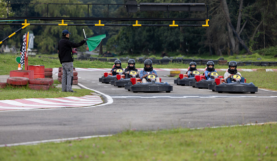 Little karting racer on the outdoor track