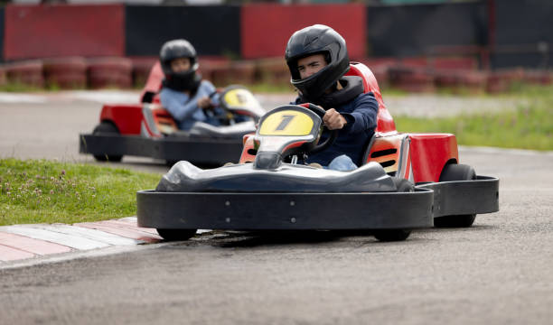 istock Competitive man racing in go-carts and holding the wheel on a turn 1393884111