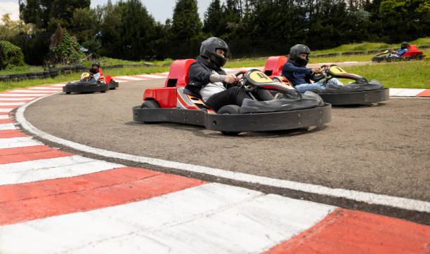 istock Competitive friends racing in go-carts 1393884118