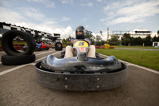 Competitive Latin American man racing in go-carts - leisure activities concepts