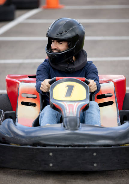 istock Happy man racing in go-carts 1393884705