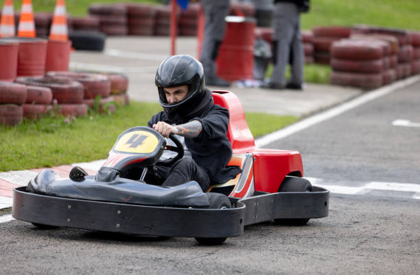 istock Competitive man go-carting and making an effort to win 1393884712