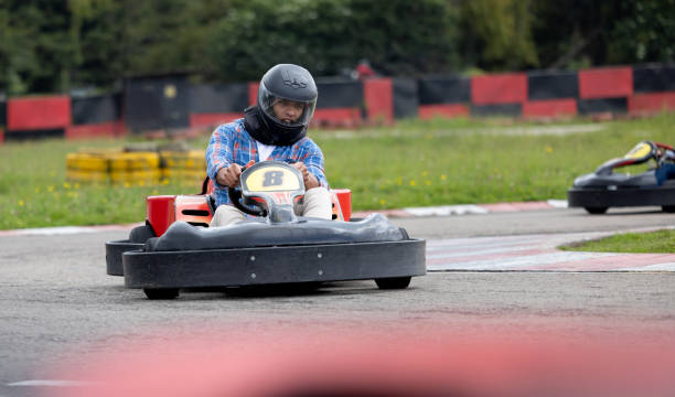 istock Competitive man racing in a go-cart track 1393884719