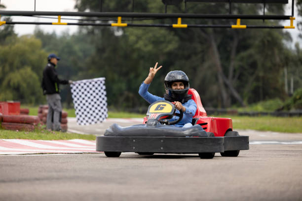 istock Happy woman having fun go-carting 1393884721