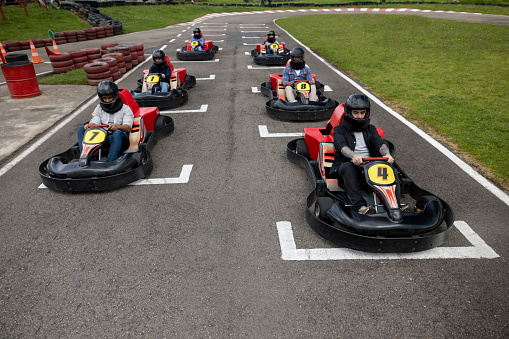 Group of Latin American go-cart drivers ready to start the race - sports race concepts