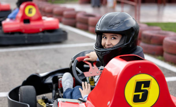 istock Woman looking happy racing in go-carts 1393884726