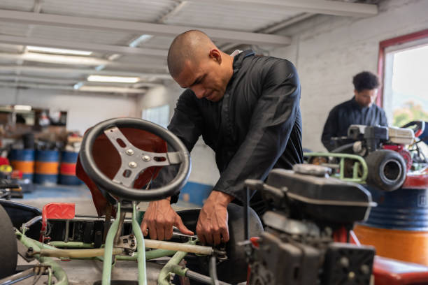 istock Mechanic working at a car garage fixing go-carts 1393884782