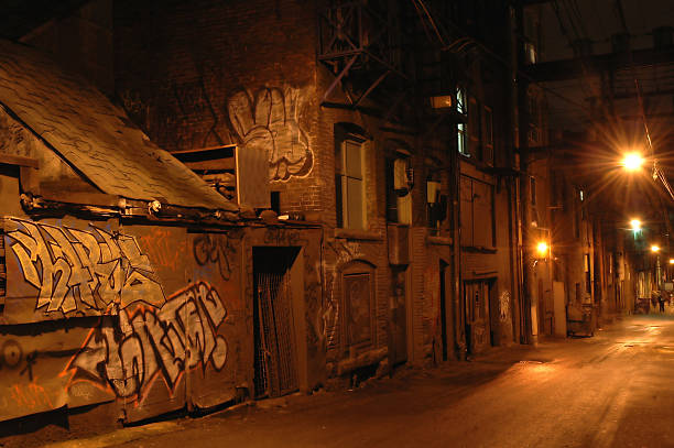 Dark Dangerous Alley A seedy looking alley at night, dark, dangerous, seedy and dirty with graffitti. seedy alley stock pictures, royalty-free photos & images