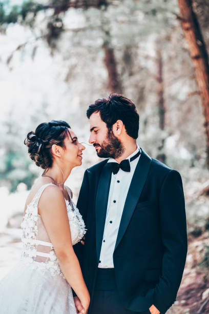 istock Wedding couple posing in forest. 1393885875