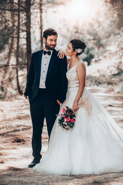 istock Wedding couple posing in forest. 1393885904