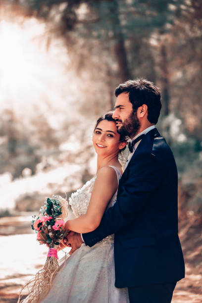 istock Wedding couple posing in forest. 1393886095