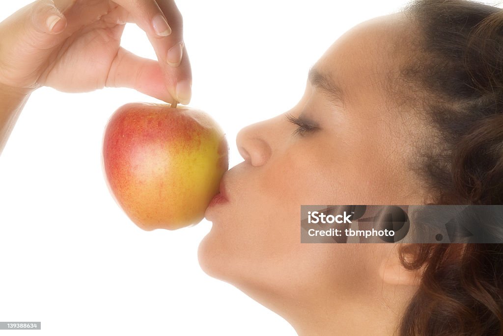 Kissing the apple Woman kissing an apple on white background Adult Stock Photo