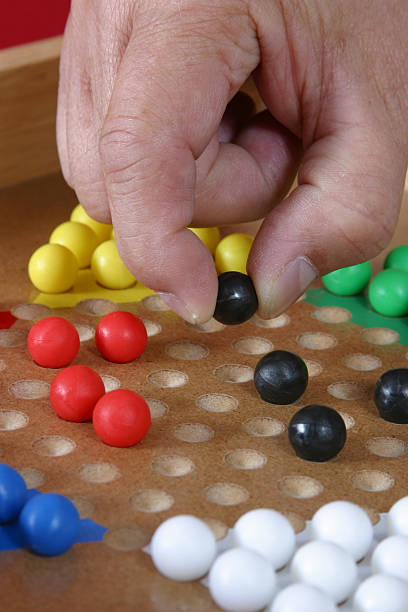 Playing Chinese Checkers Playing Chinese Checkers chinese checkers stock pictures, royalty-free photos & images