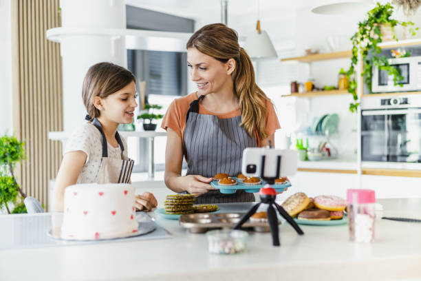 istock Mother and daughter vlogging from home 1393887743