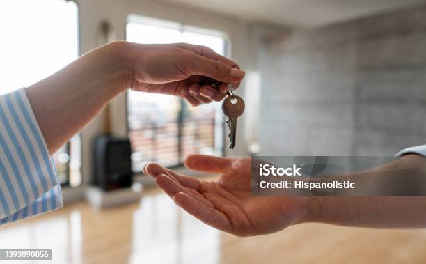 Real Estate Agent Giving The Keys Of His New House To A Man Stock Photo - Download Image Now