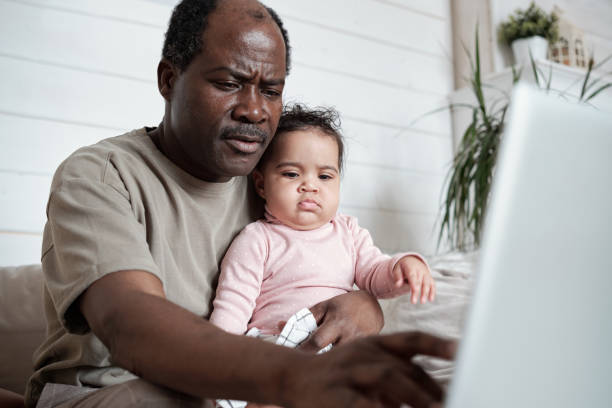 istock Busy Parent Working On Laptop 1393891688