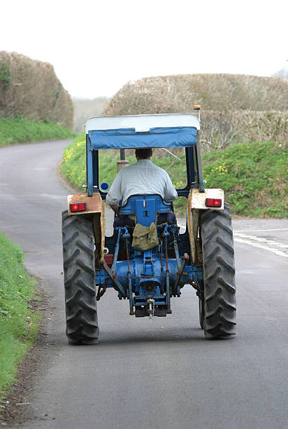 istock Blue tractor on road path at day time 139389198