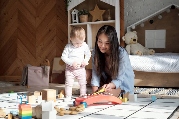 istock Mother Playing With Baby Daughter 1393892495