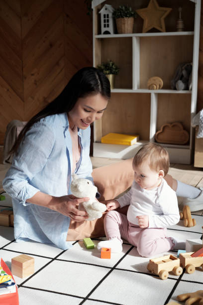 istock Woman And Baby Having Fun 1393892496