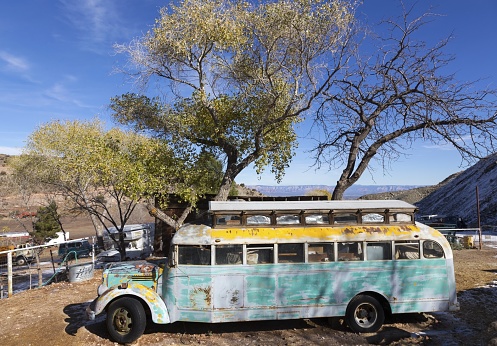 Jerome, Arizona, USA - December 1, 2021: Old Obsolete Abandoned School Bus Rusting on Vehicle Junkyard Depot
