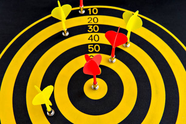istock Dart game, dartboard with red dart in the center 1393893518