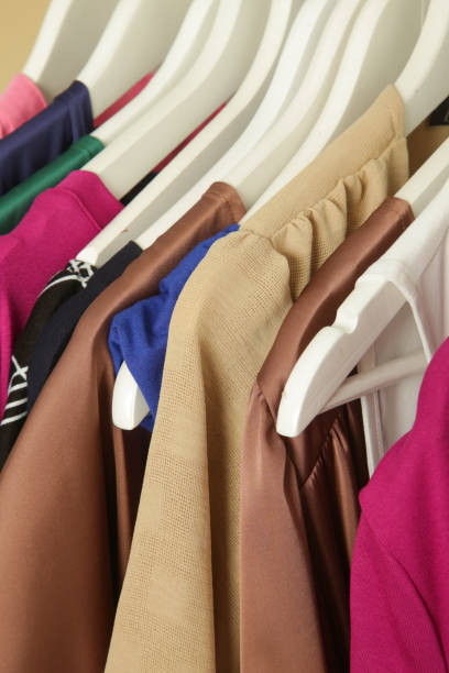 Women's fashion. Different clothes on hangers, close up. stock photo