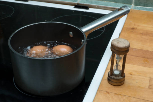 Boiling eggs in saucepan with eggtimer