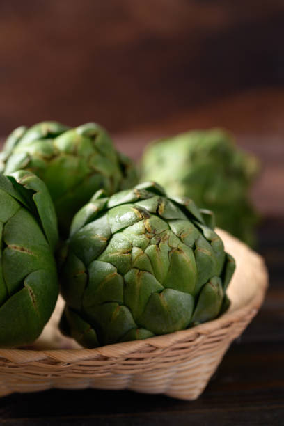 istock Green artichoke in bamboo basket 1393899798