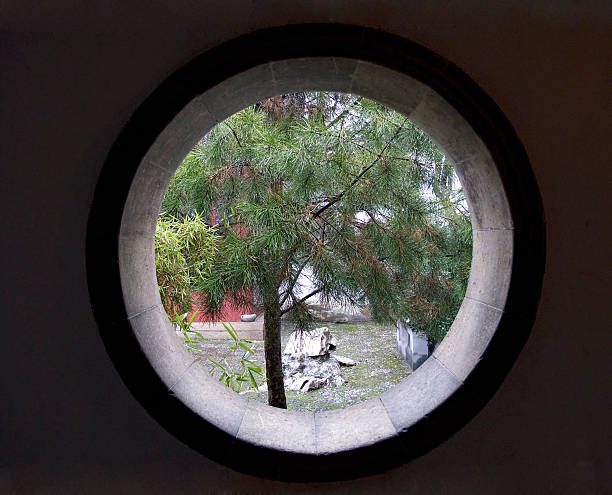 Asian round window into garden stock photo