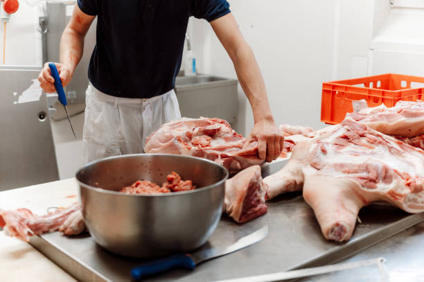istock Butcher cutting pieces of meat carcass 1393901640