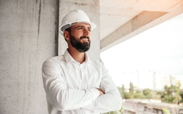 Confident architect standing on construction site stock photo