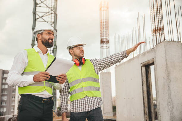 Surveyor and engineer inspecting construction site stock photo