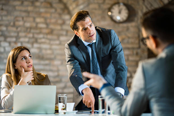 Angry manager arguing with his colleagues in the office.